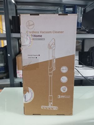 packaging of a vacuum cleaner sitting on a table in a room