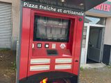 a red vending machine sitting outside of a building