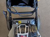 an image of a lawn mower parked in a garage