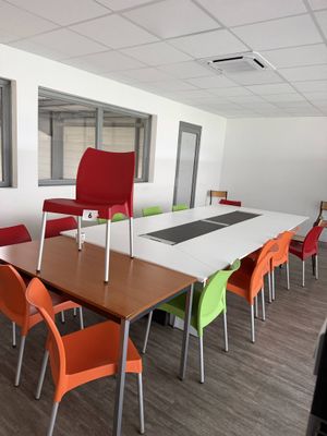 many chairs around a table in a conference room