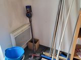 a blue bucket and a blue broom in a room