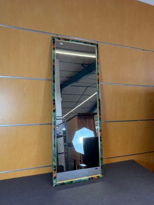 a mirror that is sitting on a table in a room