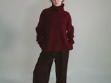 a picture of a woman in a red sweater and black pants