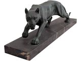 statue of a black dog on a marble base