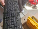 a person holding a black keyboard in their hand