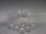 six glasses sitting on top of each other on a table