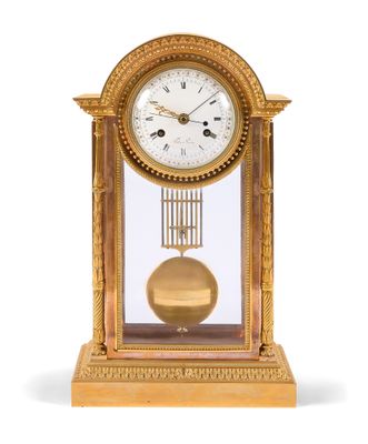 a gold clock with a pendulum on a white background