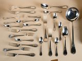 a lot of silver spoons and spoons on the table