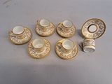six cups and saucers sitting on a table