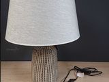 a lamp that is sitting on a table with a cord plugged into it