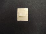 a close up of a square piece of paper on a black surface