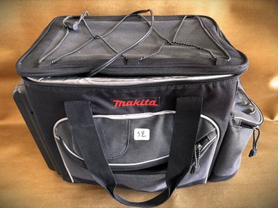 a black bag with a red makita logo on it