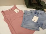two pairs of shorts and a t - shirt sitting on a table