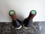 two bottles of wine that are sitting on a table