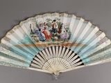 un ventilateur avec un tableau accroché au mur