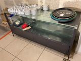 a glass display case with plates and cups on it