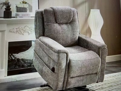a recliner chair in a living room with a fireplace in the background