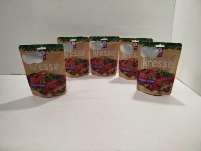 quatre sachets de produits frais sont posés sur un plan de travail blanc