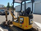 a picture of a cat excavator parked in a parking lot