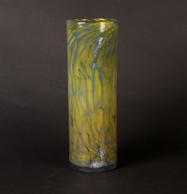 a tall glass vase with a yellow and blue swirl on it