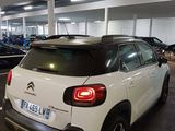 a white citrole parked in a parking garage