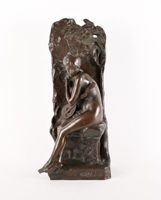 bronze statue of a woman sitting on a rock with her hands on her face