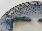 a plate with a picture of two fish on it