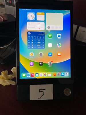 a tablet that is sitting on a table with a number on it