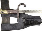 a very old looking knife with a leather sheath on it