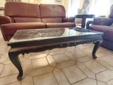 a coffee table with a glass top in a living room