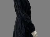 an image of a mannequin dressed in a black coat and white pants