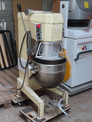a mixer sitting on a pallet next to a stove