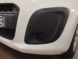a close up of a white car with a license plate on it