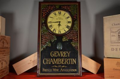 une horloge posée sur une étagère à côté de quelques cartons