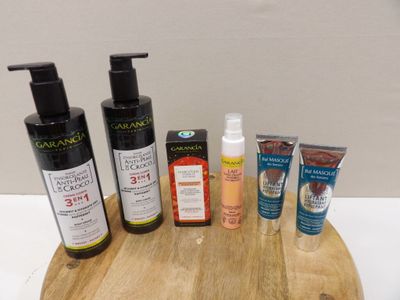 many different types of skin care products on a wooden board