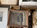 many framed pictures of men and women on the wall