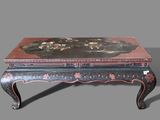 a small table with a painting on top of it