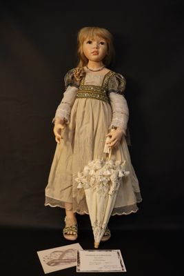 a doll that is holding an umbrella on a black background