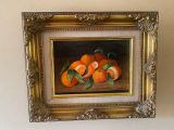 une photo d'un tableau représentant des oranges, dans un cadre doré