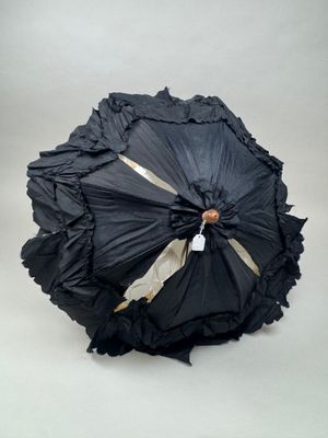 un parapluie noir orné d'une bande dorée