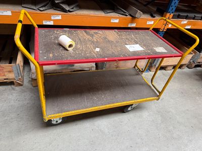 a cart with a roll of paper on it in a warehouse