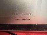 the back of a silver laptop computer sitting on top of a red table