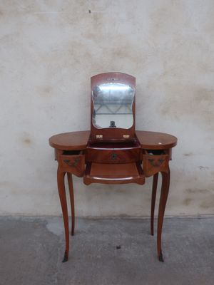 a small wooden table with a mirror on top of it