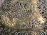 a large metal vase with a decorative design on it