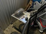 a machine that is sitting on the floor next to a pile of trash