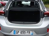 a silver car with its trunk open in a parking lot