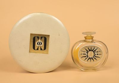 a small bottle of perfume next to a small bottle of perfume