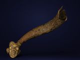 a close up of a brass pipe with a face on it