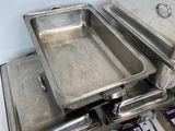several trays of food sitting on top of each other on a counter