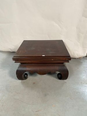 an image of a small wooden table on wheels with a white background